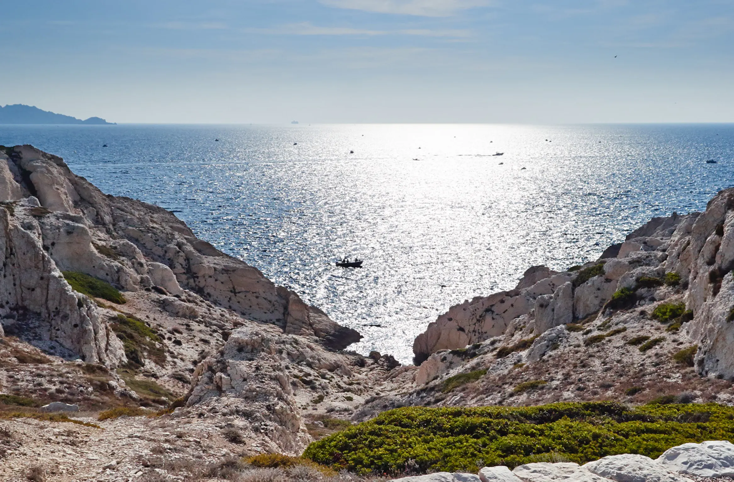 A sunny Marseille calanque with sparkling sea and white rocks